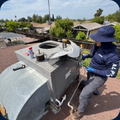Alpha technician servicing rooftop equipment