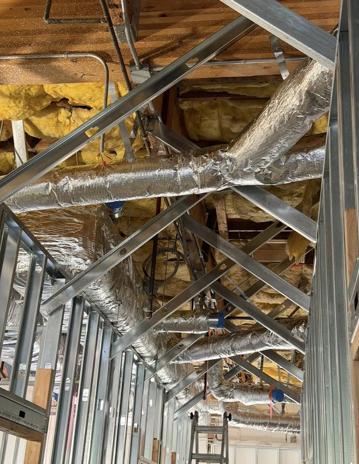 Insulated HVAC ductwork above interior framing