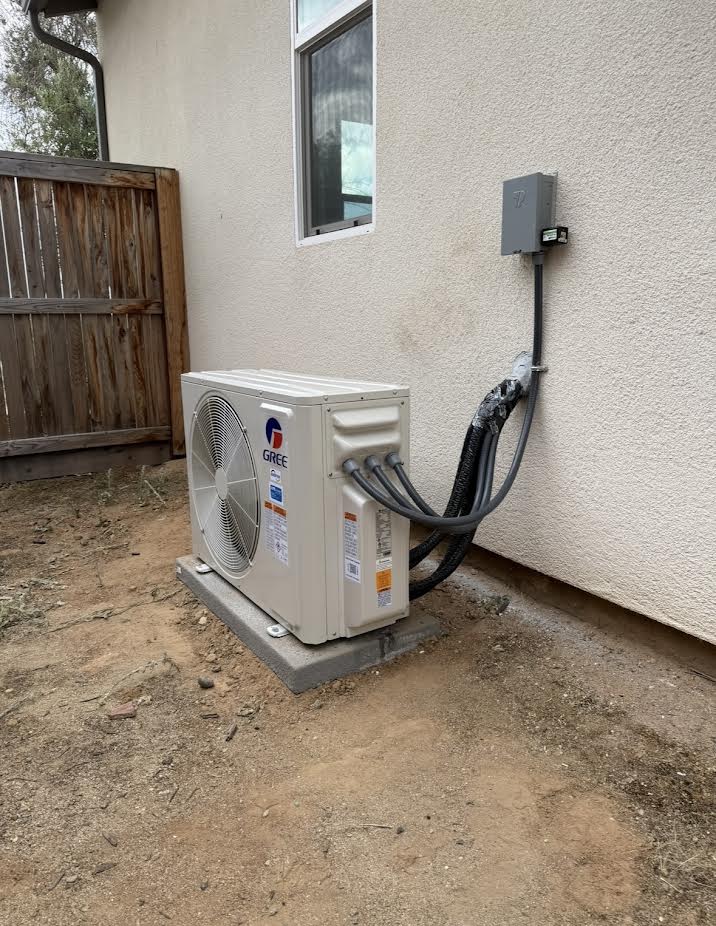 Outdoor Gree mini split beside a home